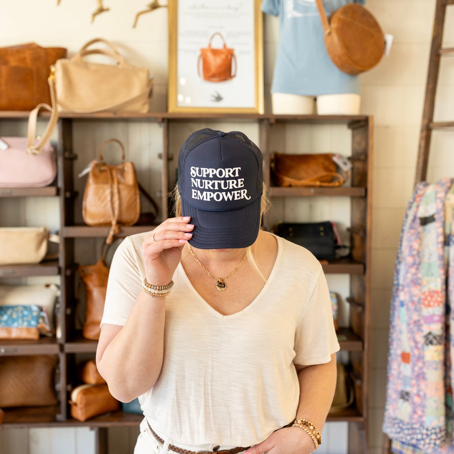 Support. Nurture. Empower. Trucker Hat